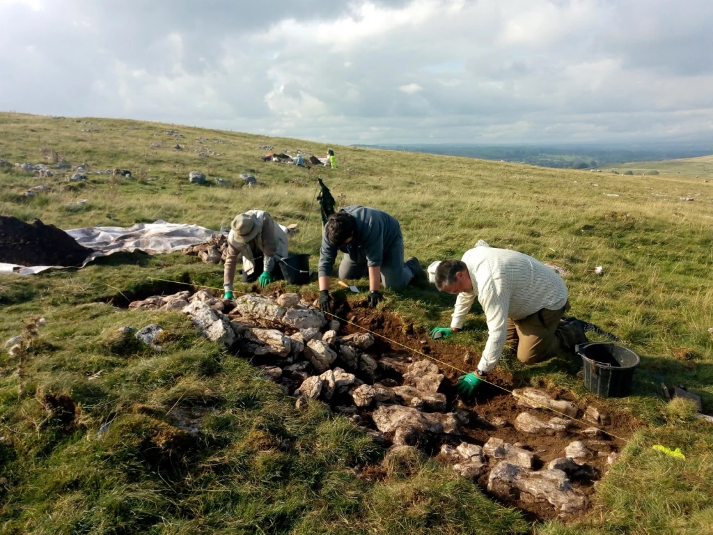 volunteers excavating trench