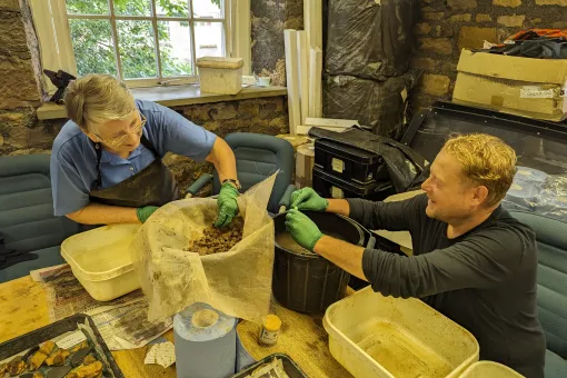 Volunteer Lynn and archaeologist Richard washing finds in the Lancaster office