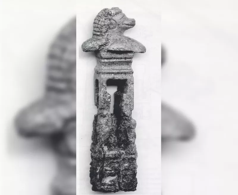 a rectangular stone key handle with the head in the shape of a beast