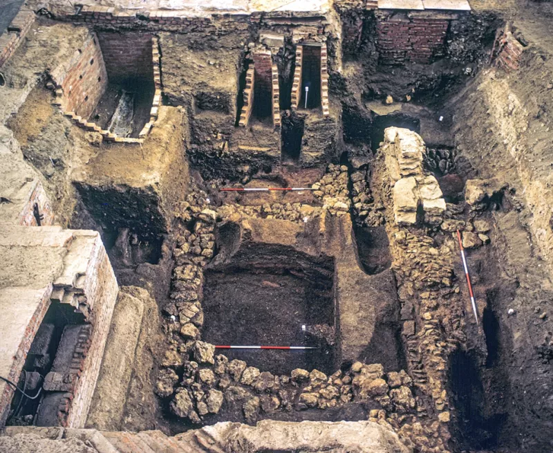 an overview shot of the excavation site, it has stone structures in every corner and centre of image