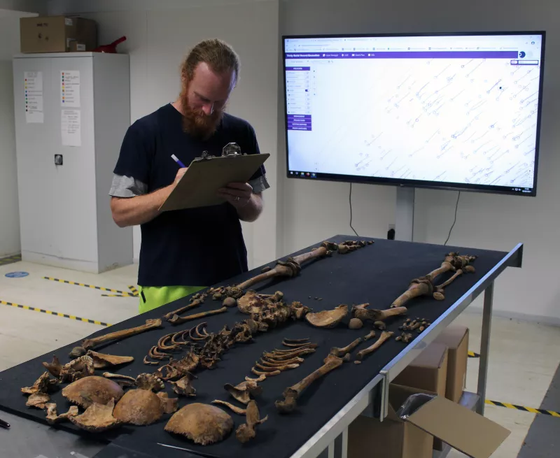 An osteologist records a skeleton