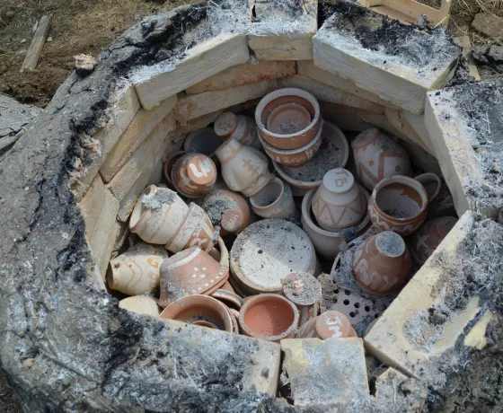 A replica Roman kiln full of pots