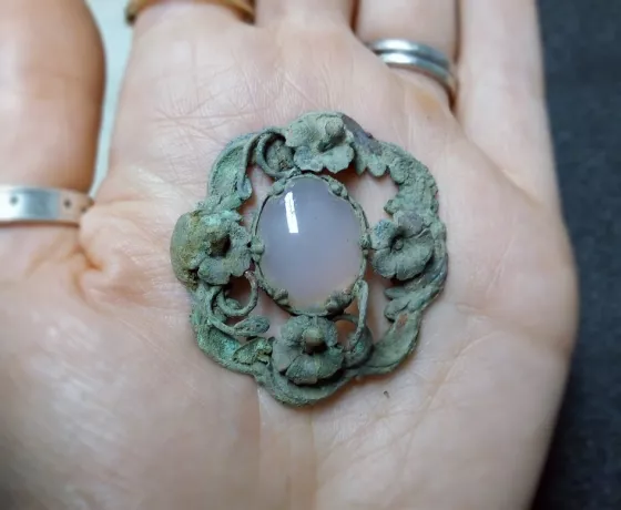 A pendant found with one of the burials held on someones palm